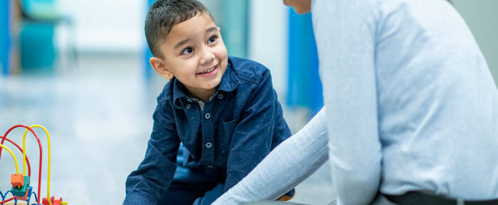 ABA therapist play therapy with young boy