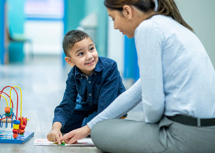 ABA therapist play therapy with young boy