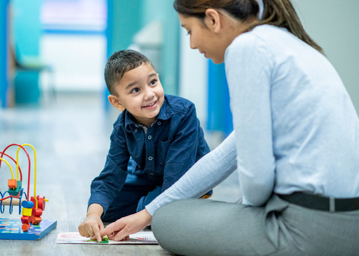 young boy working with aba therapist