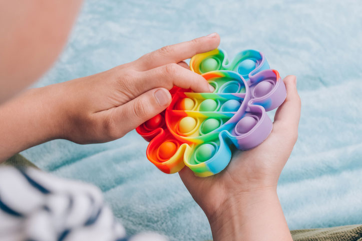 boy playing with a fidget pop-it