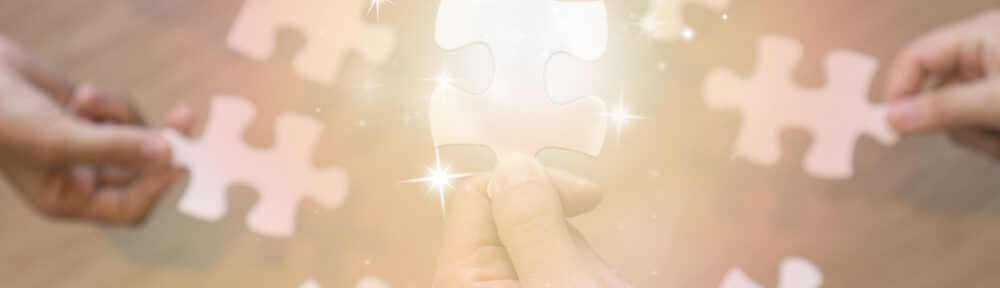 hands holding pieces of jigsaw as a symbol for ASD