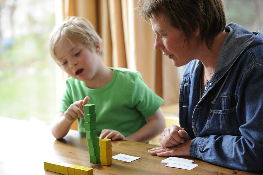 teacher and student counting blocks