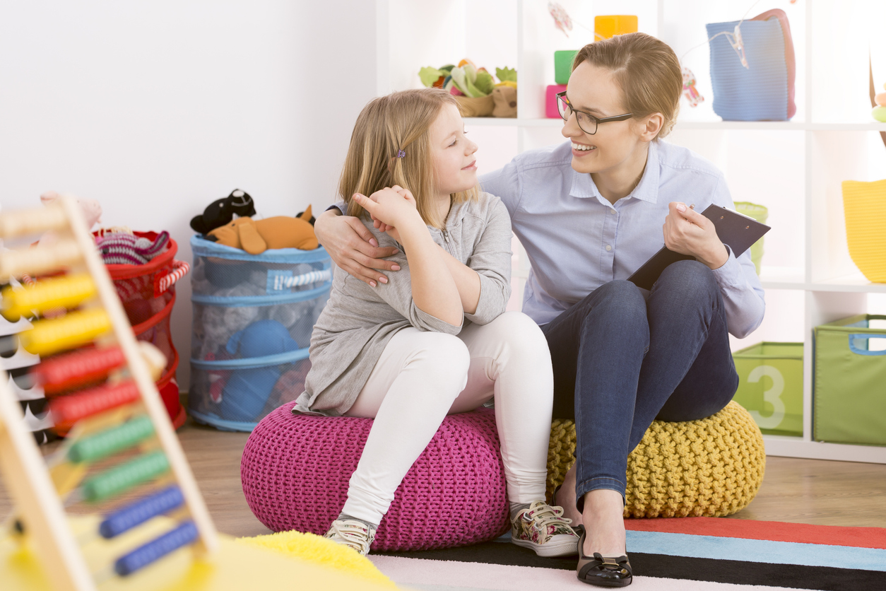 ABA therapist in a playroom