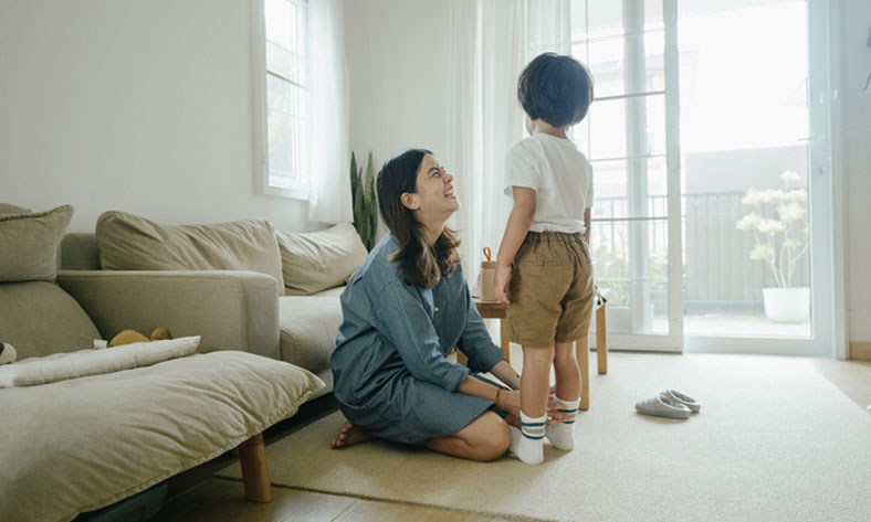 mom dressing boy