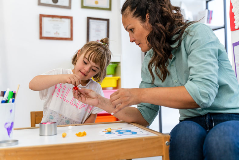 pupil and teacher working on math