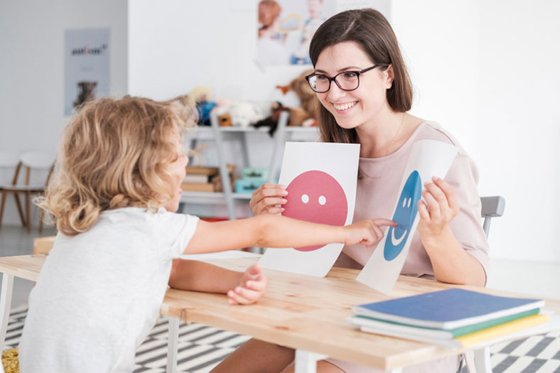 smiling therapist working with child