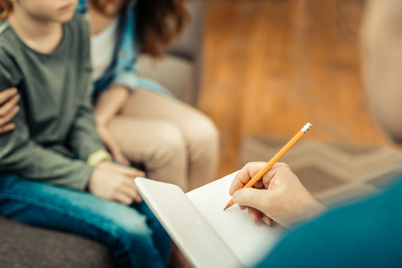 therapist with open notebook in session