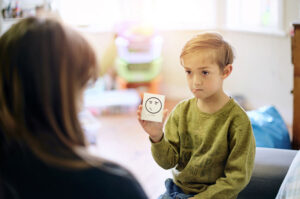 young boy talking to therapist 